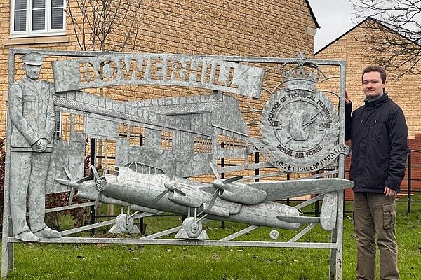 Keates standing next to the sign for Bowerhill