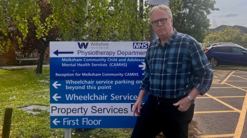 Brian by the Melksham Hospital sign