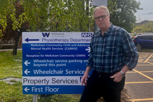 Brian by the Melksham Hospital sign